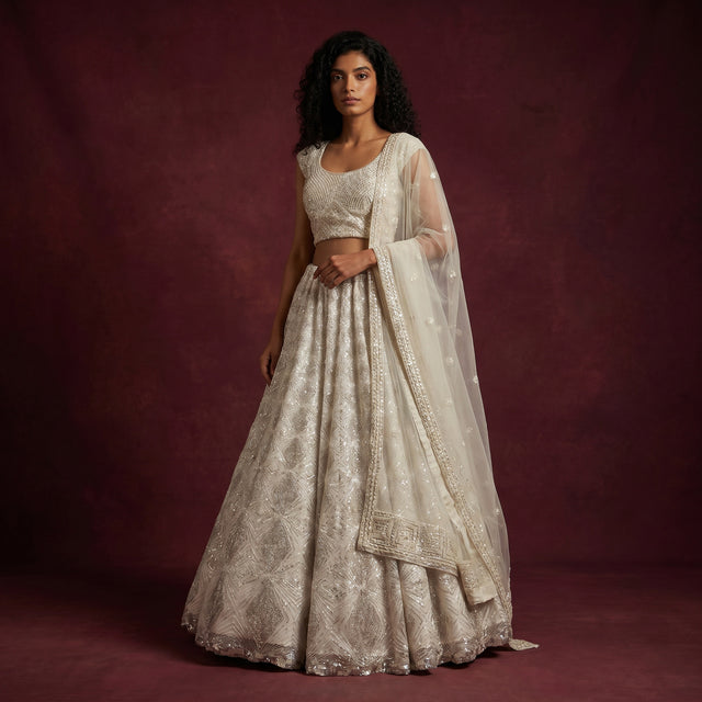 Off-white embellished lehenga with blouse and sheer dupatta, silver cutdana lattice