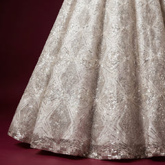 Off-white net lehenga skirt with silver cutdana lattice and diamond embellishment