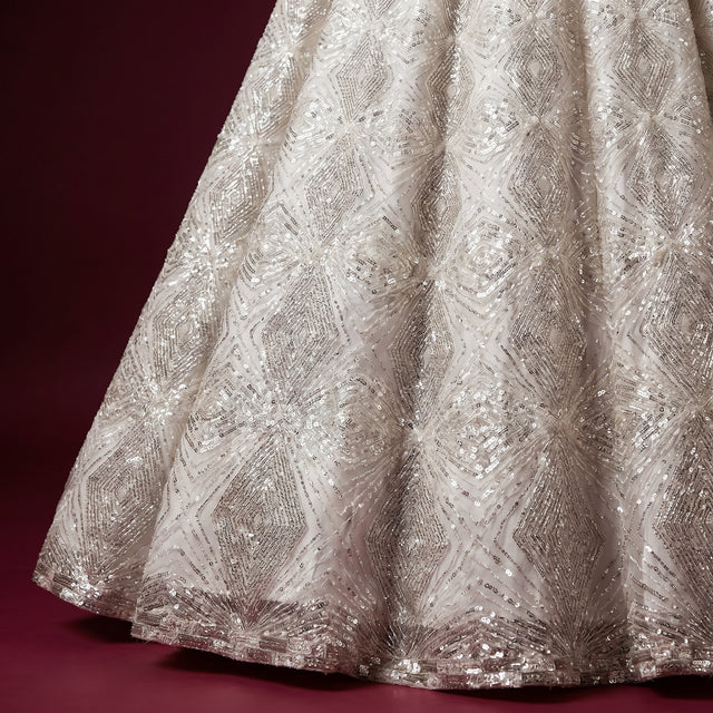 Off-white net lehenga skirt with silver cutdana lattice and diamond embellishment