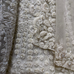 Close-up of white floral 3D embroidery with beadwork on lehenga fabric