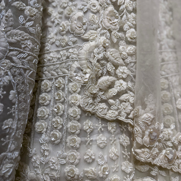 Close-up of white floral 3D embroidery with beadwork on lehenga fabric
