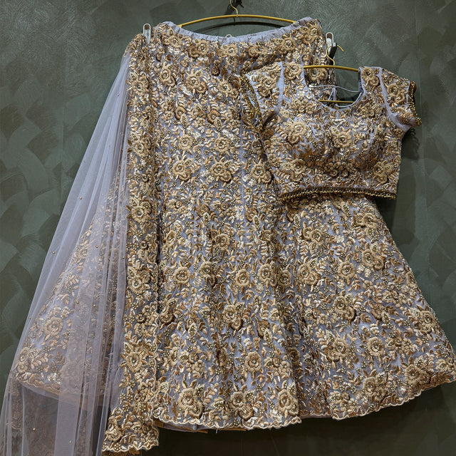 Lavender and gold embroidered flared lehenga on hanger with sheer dupatta