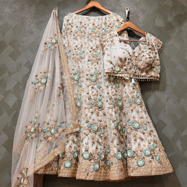 Off-white net lehenga set on hangers with 3D floral resham and golden zari work, sheer dupatta