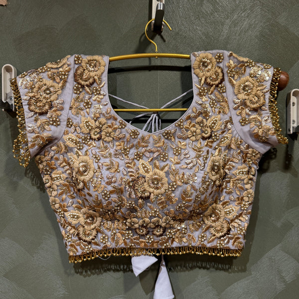 Lavender lehenga blouse with golden zari, moti-style beadwork, and embroidered cap sleeves