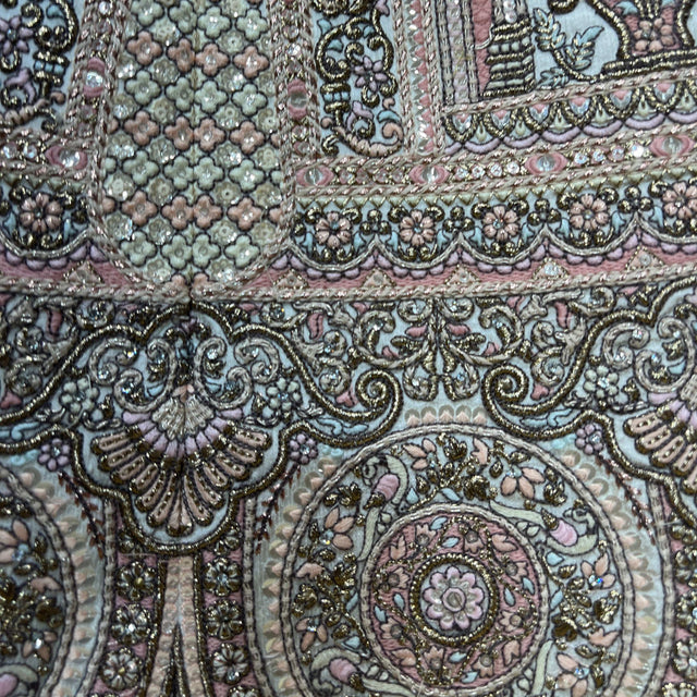 Embroidered lehenga border with ornate floral scrollwork and bead-like accents