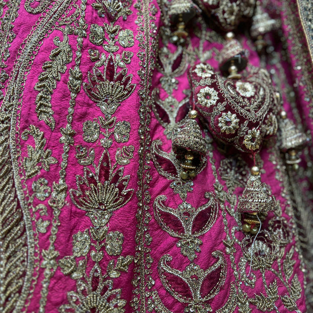 Fuchsia velvet fabric with dense silver-toned floral embroidery and beaded details