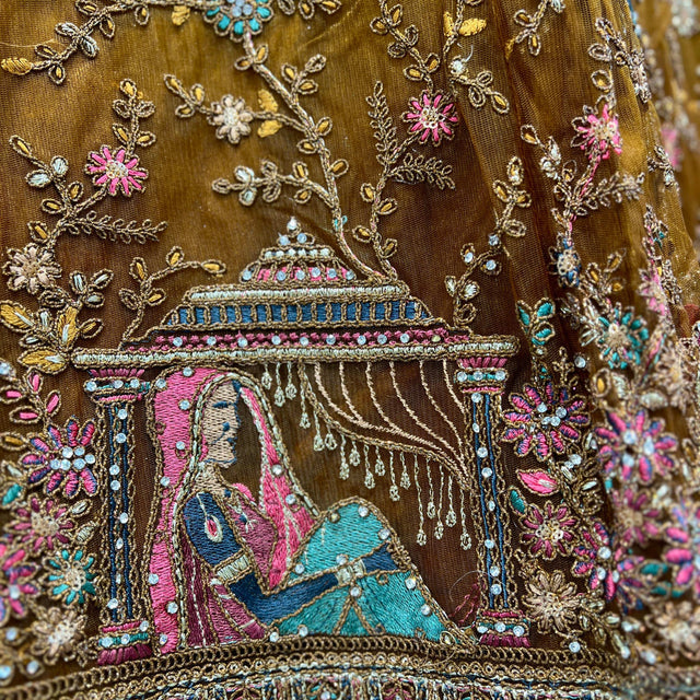 Gold-toned fabric with dense bead and thread embroidery, floral and paisley motifs
