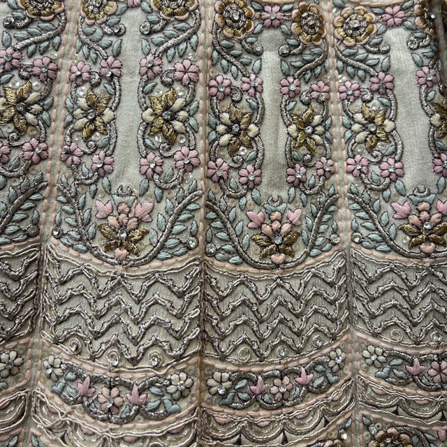 Off-white fabric with multicolor floral embroidery and beadwork, scalloped trim pattern