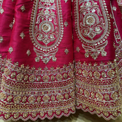Rani pink lehenga skirt and bodice close-up with gold and silver embroidered borders