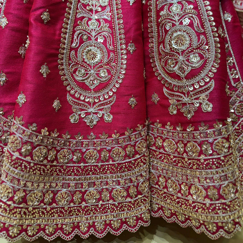 Rani pink lehenga skirt and bodice close-up with gold and silver embroidered borders