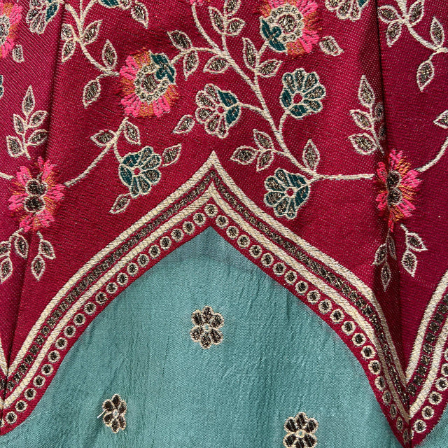 Maroon and teal lehenga bodice with floral embroidery and gold border trim