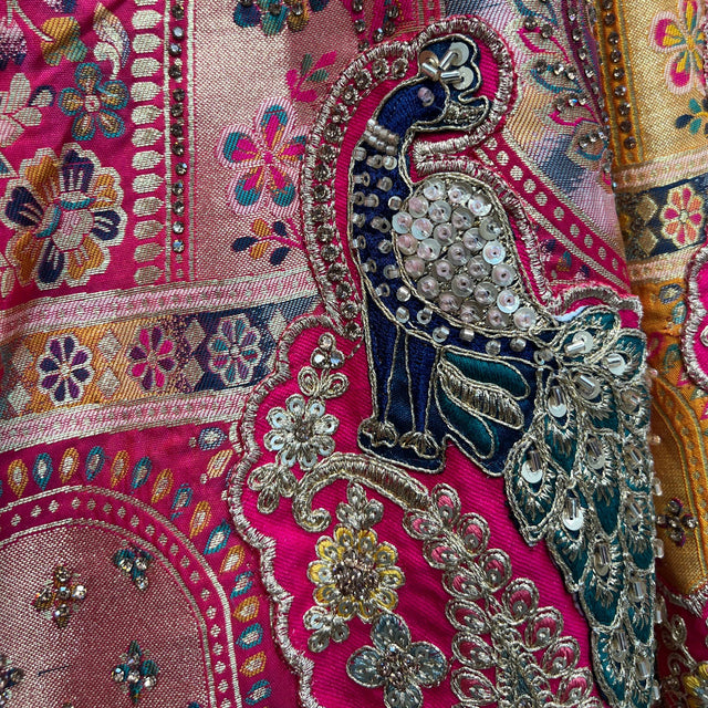 Embroidered lehenga border with silver sequins and beadwork on magenta fabric