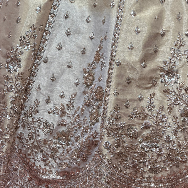 Close-up of offwhite lehenga fabric with dense gold and silver bead embroidery