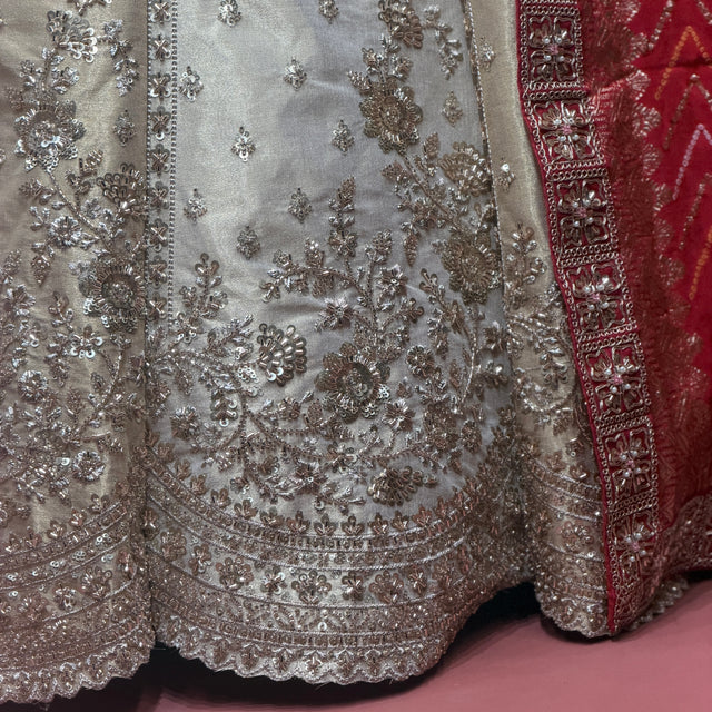 Ivory gold lehenga hem with silver embroidery and red dupatta border trim