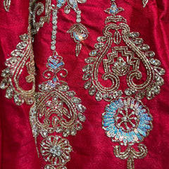 Royal red lehenga fabric with intricate gold, bead, and sequin motif embroidery