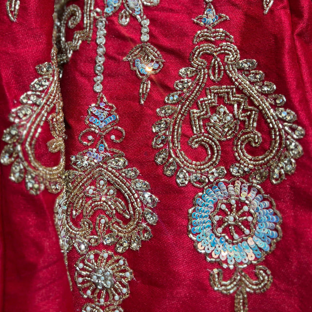 Royal red lehenga fabric with intricate gold, bead, and sequin motif embroidery