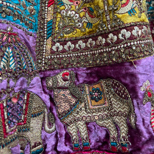 Purple velvet lehenga detail with embroidered elephant motif, beads, and sequins