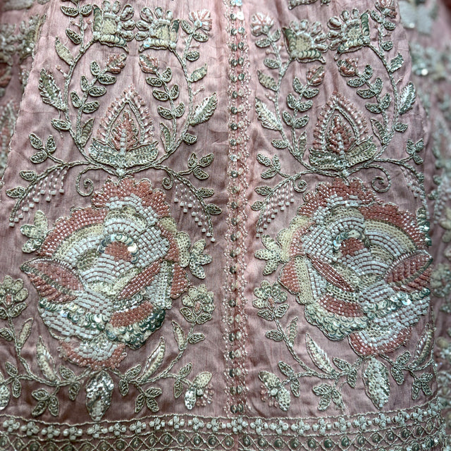 Embroidered pink fabric with beadwork floral motifs, green and silver details