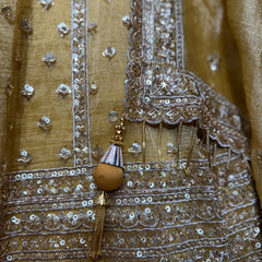 Somber yellow lehenga fabric with ornate mirror and sequin embellishment trim