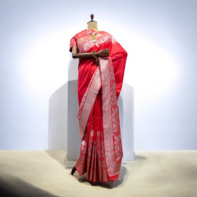 Red Kanjivaram-style saree with gold zari pallu and draped pleated skirt