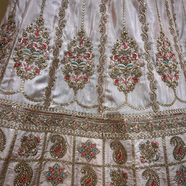 Pastel pink lehenga skirt detail with multicolor embroidery and gold beadwork