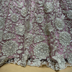 Blush net fabric with white cutdana and beadwork floral motifs