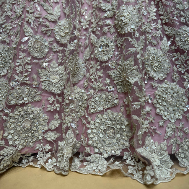 Blush net fabric with white cutdana and beadwork floral motifs