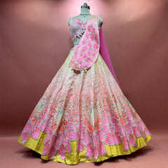Full peach, coral and pink raw silk lehenga with mustard hem, blouse and embroidered drape dupatta with pink net on a mannequin