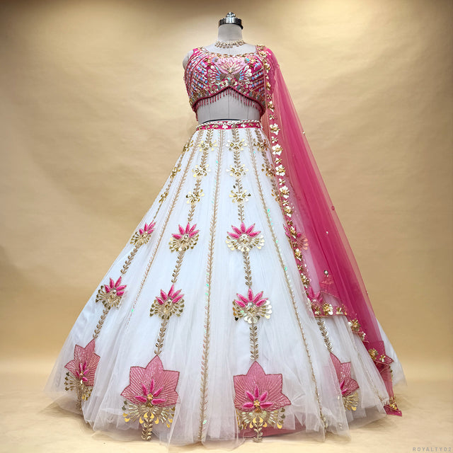 Ivory lehenga skirt with pink floral threadwork, embellished bodice and sheer dupatta