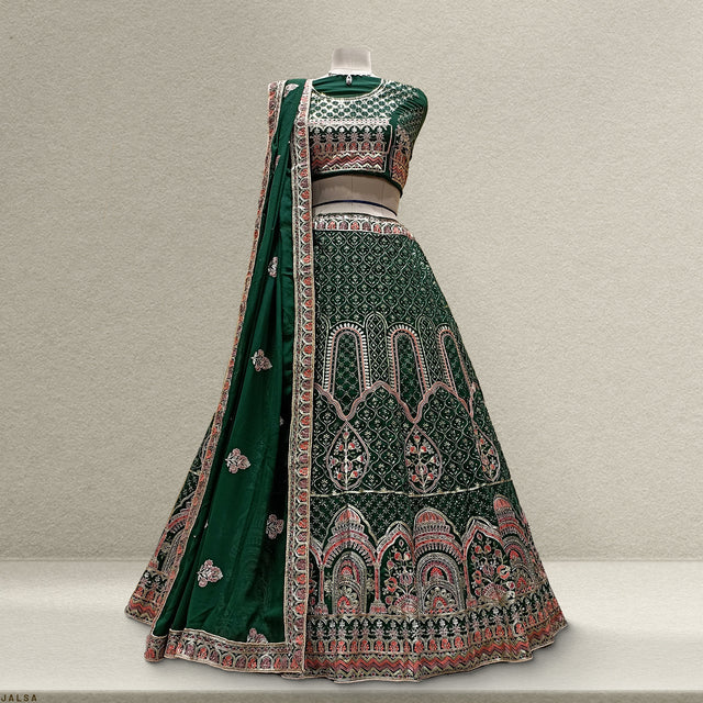 Bottle-green embroidered lehenga with flared skirt, detailed borders, and sheer dupatta