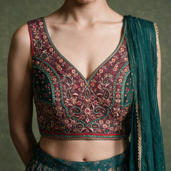 Close-up of the wine sleeveless blouse with floral and paisley embroidery in gold, pink and teal, and the teal chinon dupatta with gold stripes