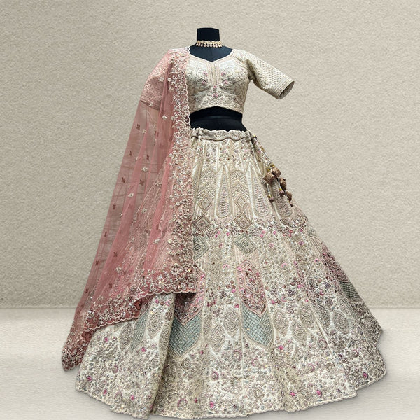 Ivory embroidered lehenga with long pink net dupatta and beaded latkans