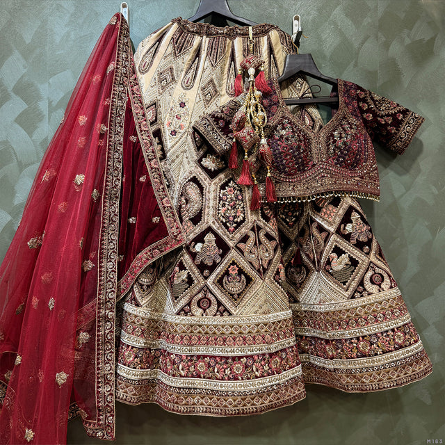 Velvet bridal lehenga with maroon dupatta and ornate silver-toned skirt