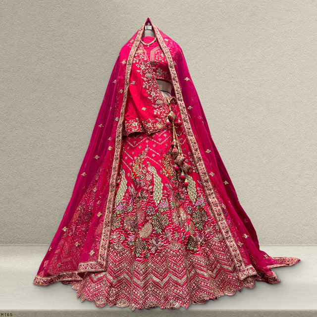 Rani pink bridal lehenga with gold embroidery and matching dupatta, full flared skirt