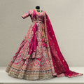 Rani pink bridal lehenga with embroidered flared skirt and draped matching dupatta