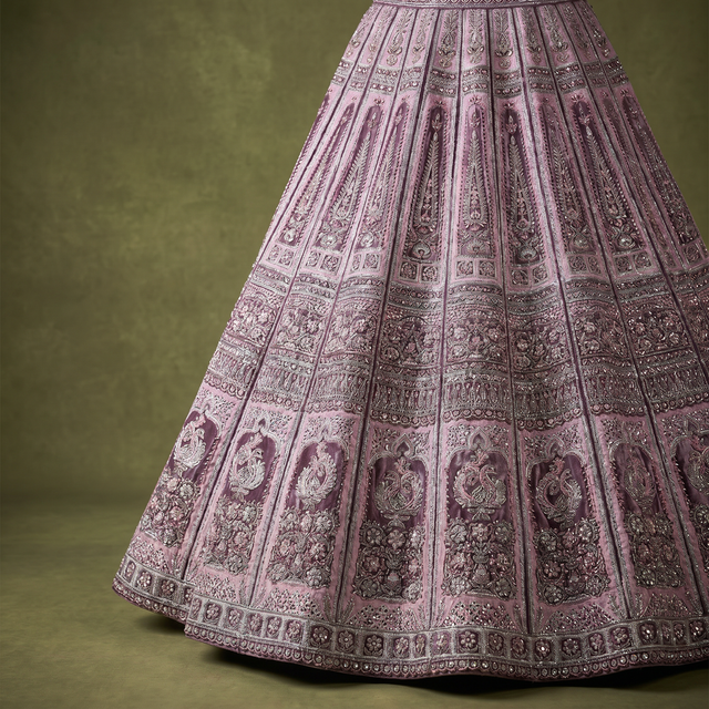 Lavender lehenga skirt with dense embroidered motifs and wide decorative border