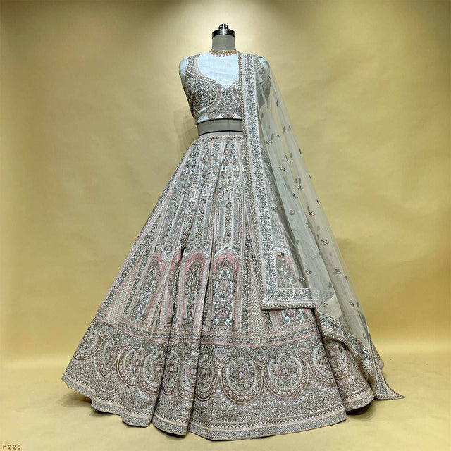 Off-white raw silk lehenga with silver embroidery, flared skirt and embellished bodice