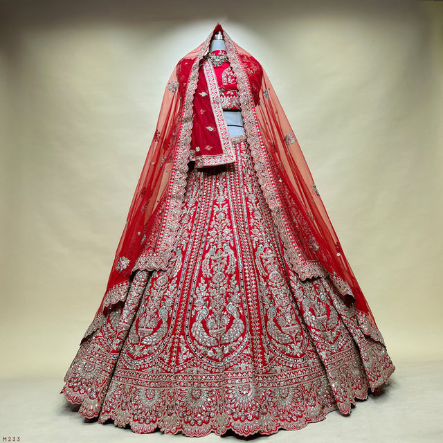 Red bridal lehenga with mirror work, zari peacock motifs and double dupatta