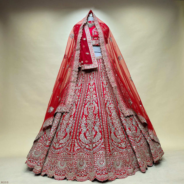 Red bridal lehenga with flared embroidered skirt and sheer dupatta veil