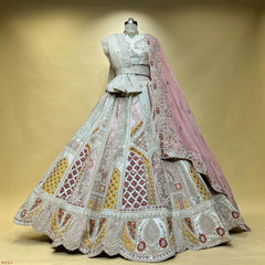 Ivory and baby pink patchwork lehenga on a mannequin with ivory net dupatta, belt and baby pink organza dupatta