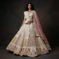 Pastel patchwork bridal lehenga with embroidered flared skirt and matching dupatta