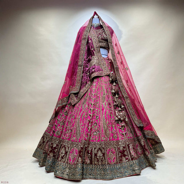 Maroon bridal lehenga with velvet dupatta, ornate silver-gold embroidery and ruffled hem