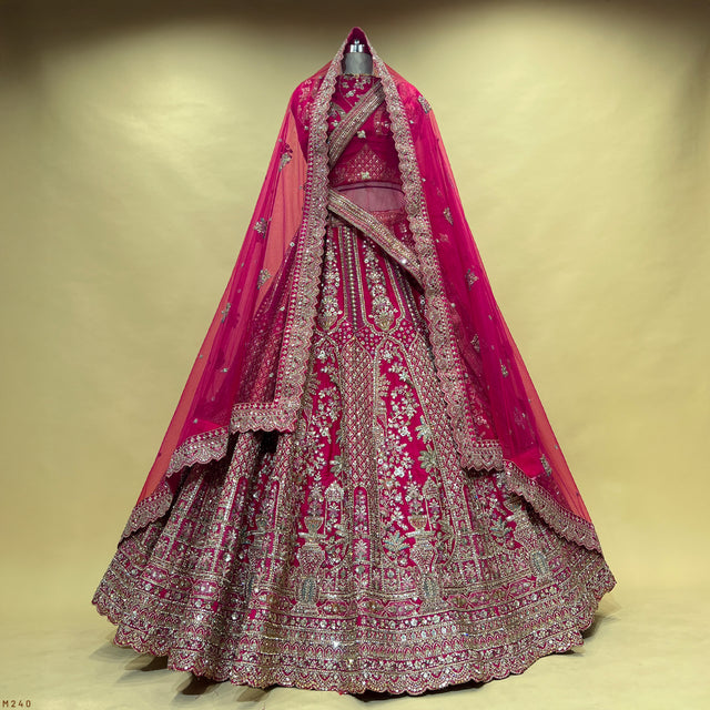 Rani pink bridal lehenga with silver zari and stonework, kalash-style double dupatta