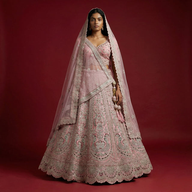Soft pink bridal lehenga with ornate embroidery and double dupatta veil