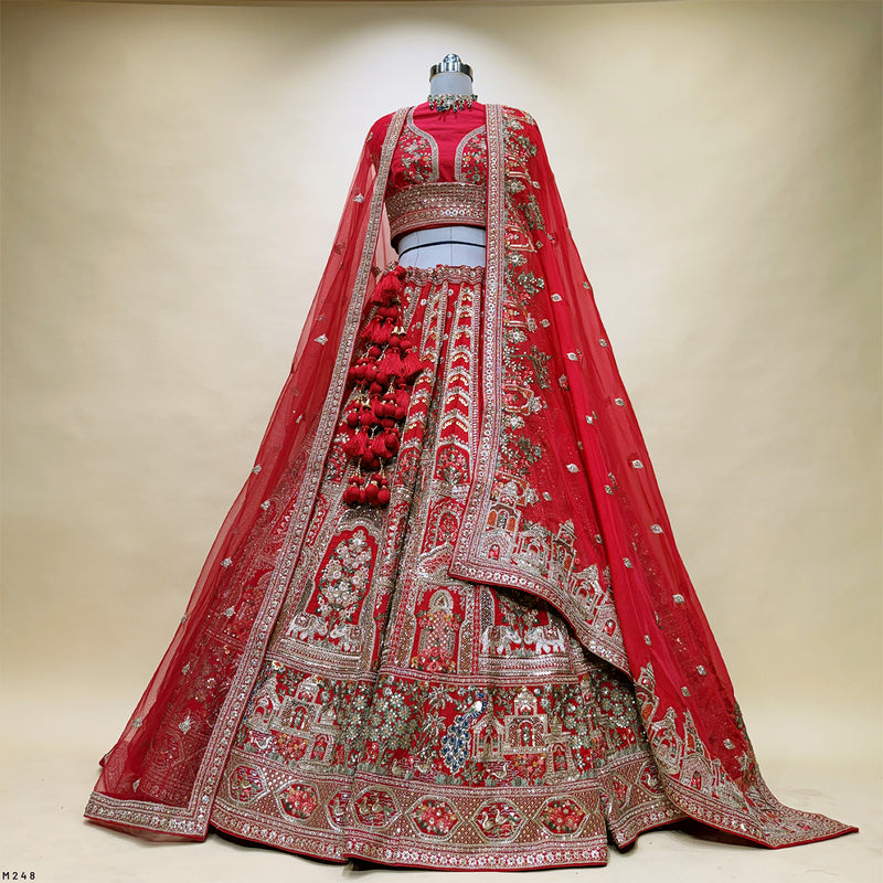 Red bridal lehenga skirt with dense embroidered motifs and silver-toned border, with dupatta.