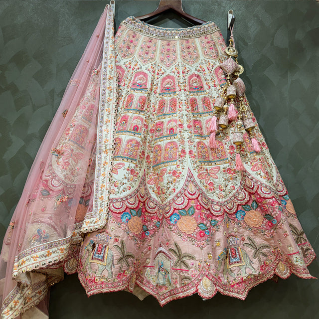 Ivory bridal lehenga with ornate multicolour embroidery and sheer pink dupatta
