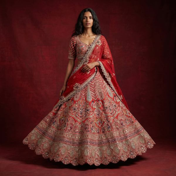 Red bridal lehenga with ornate gold embroidery and double dupatta, full flare skirt