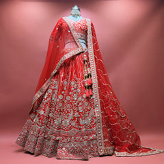 Red bridal lehenga skirt and blouse with ornate floral embroidery, layered hem, dupatta