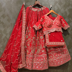 Red bridal lehenga with embroidered floral motifs, beaded belt, and matching dupatta