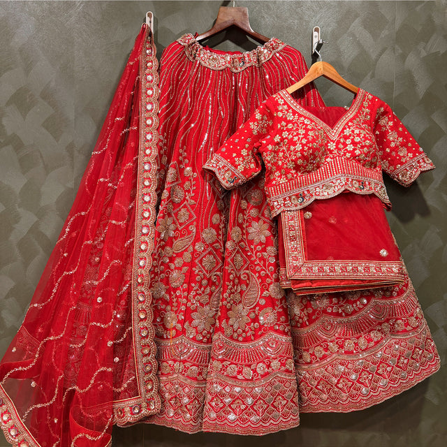 Red bridal lehenga with embroidered floral motifs, beaded belt, and matching dupatta
